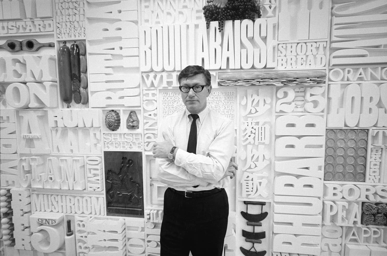 Lou Dorfsman in front of the finished wall, circa 1966